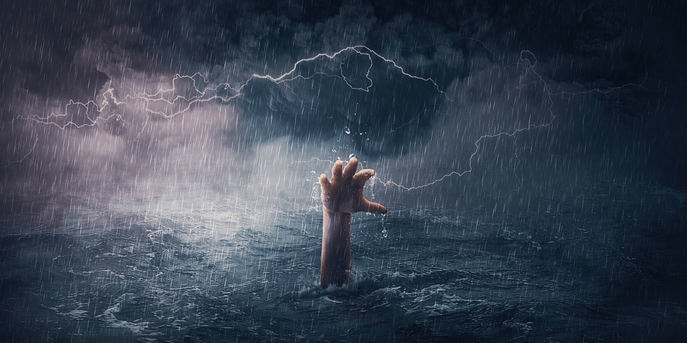 Image: A hand reaching out from the rough sea in a big storm. Image: A hand reaching out from the rough sea in a big storm.